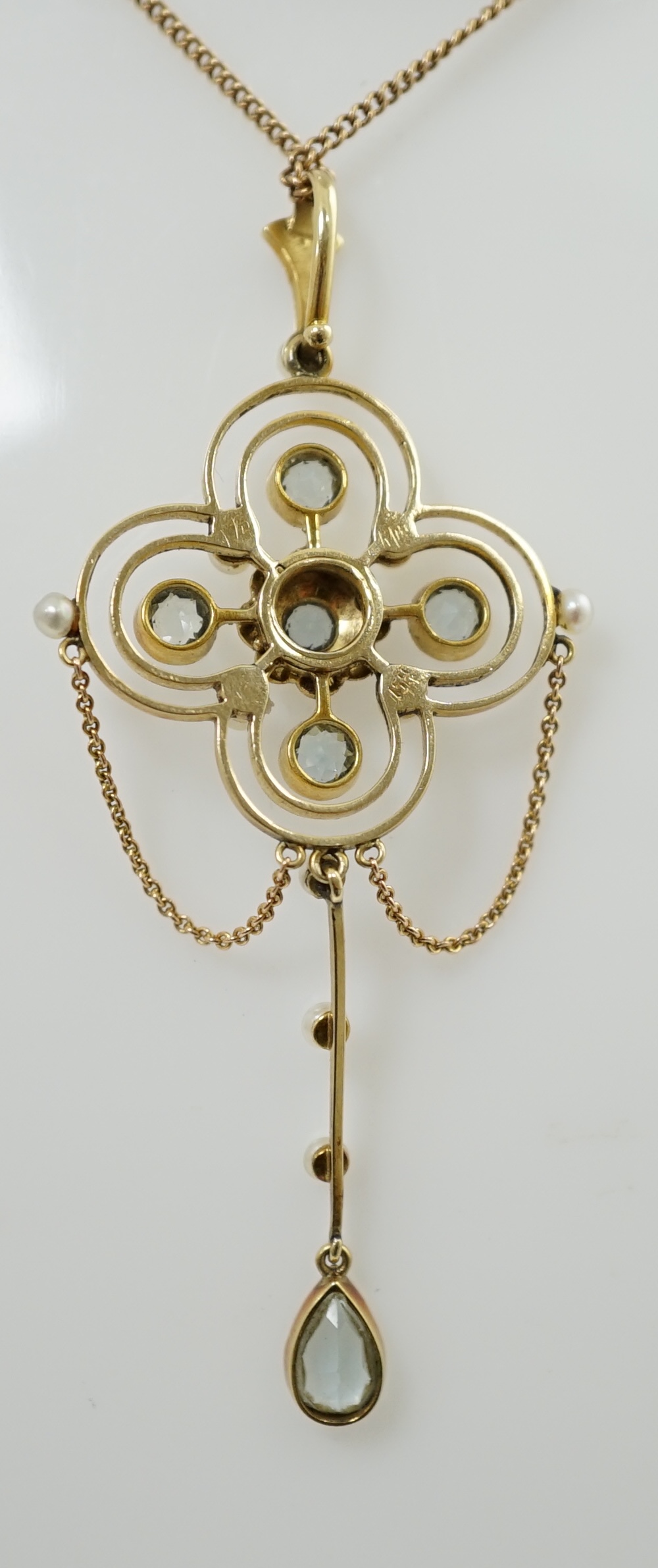 An Edwardian 15ct gold, aquamarine and seed pearl cluster set drop pendant, on a 15ct gold fine link chain